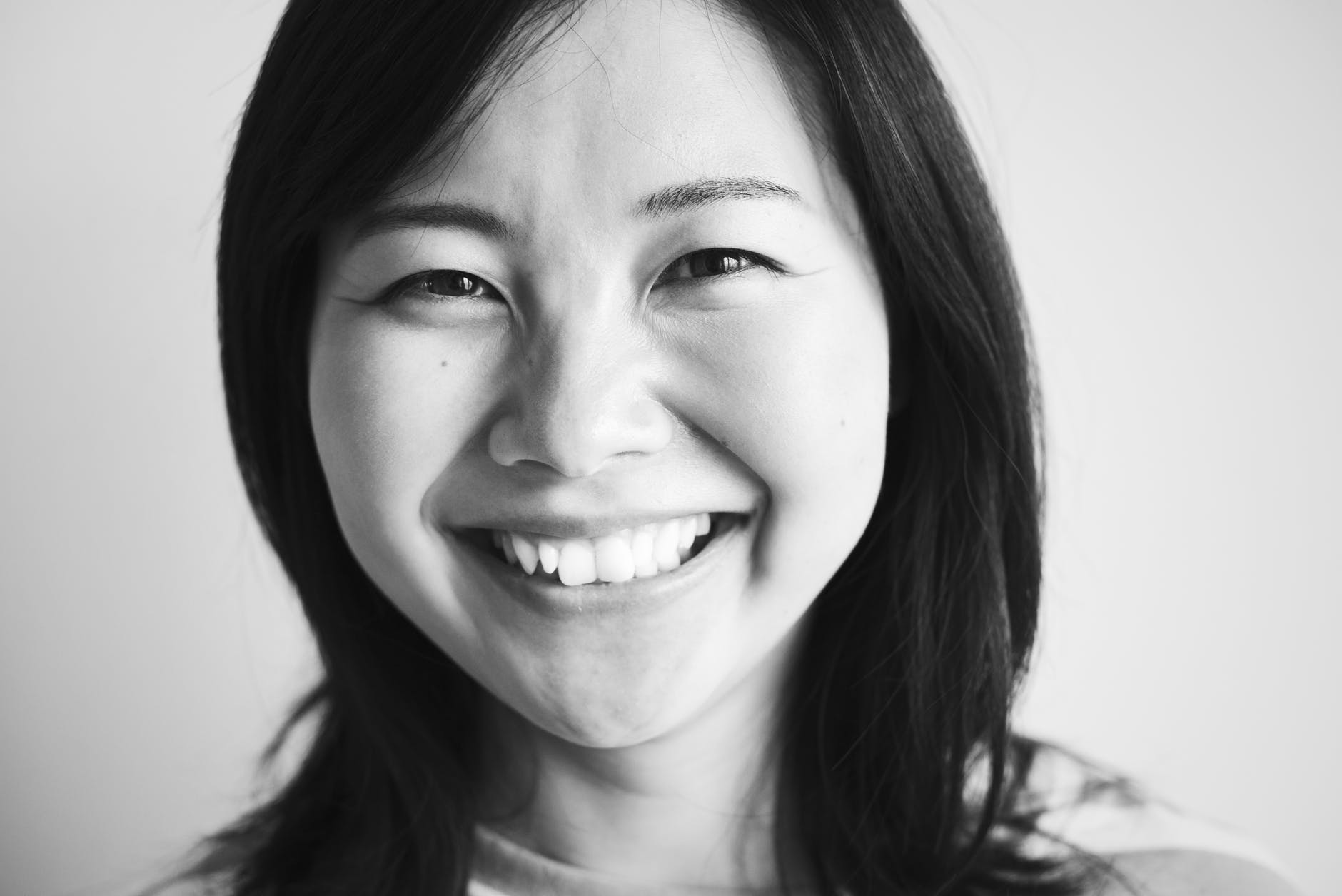 grayscale portrait photo of a woman smiling
